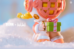 Toy figurine holding a present, close-up of gift box, pink and yellow toy - Sank Toys X DODO Nami Snow Angel - Preorder.