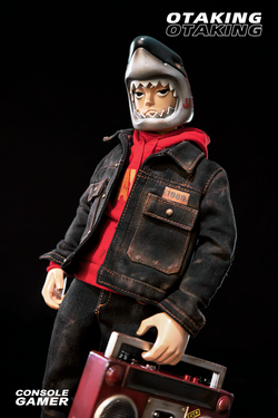 A toy doll in a red shirt and helmet, part of OTAKING - Console Gamer set with various accessories.