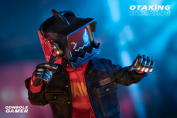 OTAKING - Console Gamer: Person in robot mask with headphones, arcade accessories, and skateboard.