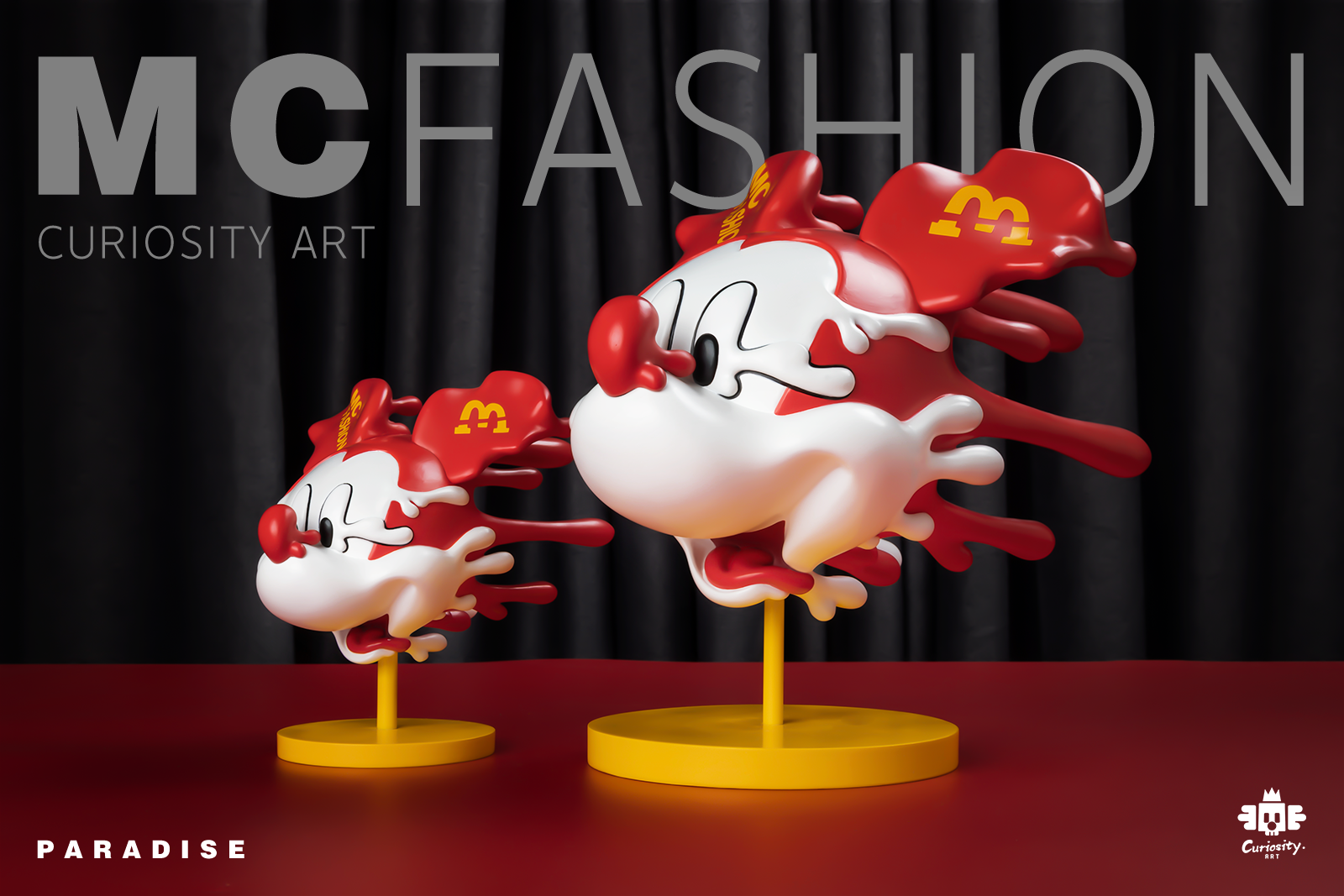 Mc Fashion - Paradise - Red cartoon character figurines on stands, one with a yellow object.