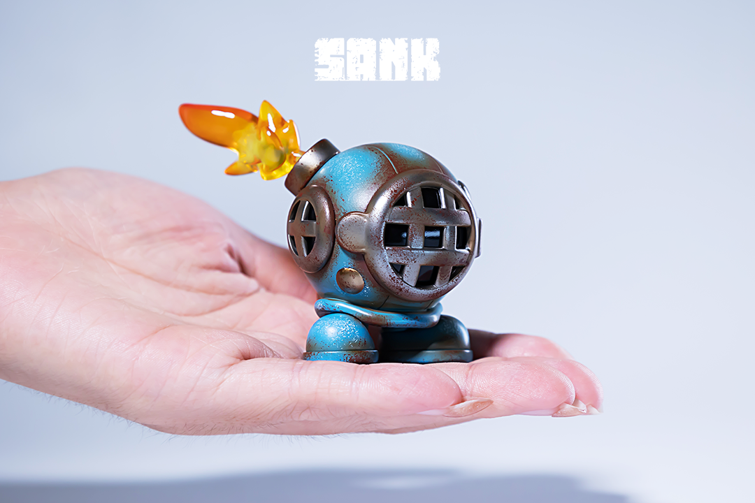 Alt text: Hand holding Tiny Sank-Blues limited edition resin toy, available for preorder.