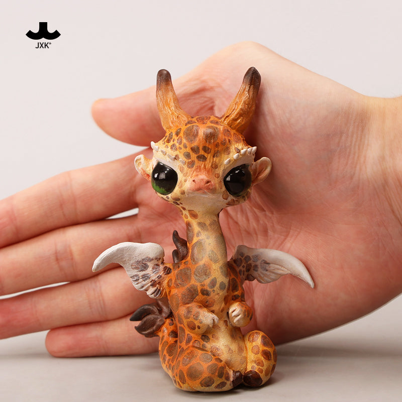 JXK-Magical Elf Giraffe figurine held in hand, showcasing its intricate resin design. Preorder for May 2025, limited edition collectible from Strangecat Toys.