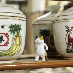 Cat Kung Fu Clinic Blind Box figurine in front of porcelain jars, showcasing a preorder item from the art toy collection, available Q3 2025.