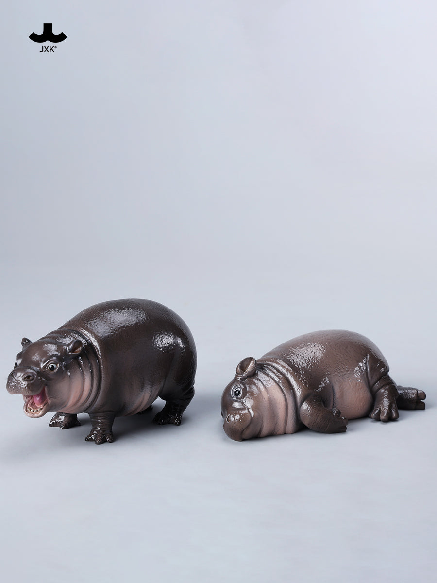 JXK-Baby Hippopotamus Figurine-MooDeng 3, resin figurine depicting a playful hippo, part of Strangecat Toys' art toy collection. Preorder, ships April 2025.