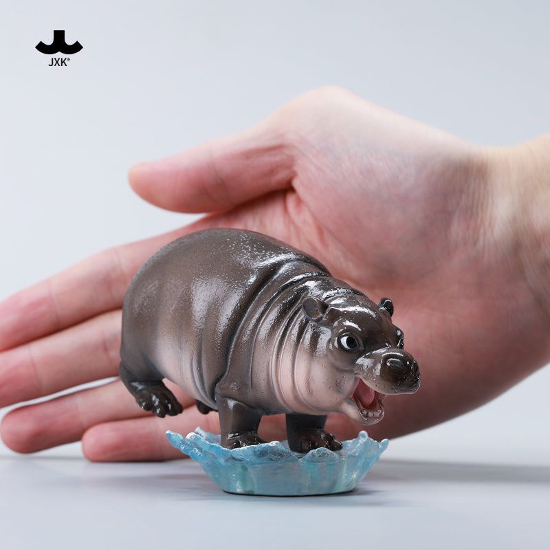 JXK-Baby Hippopotamus Figurine-MooDeng 4.0, preorder item, shown being held in a hand, highlighting its compact size and resin craftsmanship.