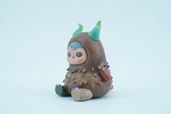 Hand-painted Monster Beanie toy with horns and face, close-up of figurine foot, 8.05cm PU.