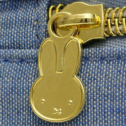 A gold bunny face zipper on Miffy - Siffler Shoulder Bag Blue, a versatile dungaree fabric bag with Miffy design accents, ideal for daily use and travel. © Mercis bv.