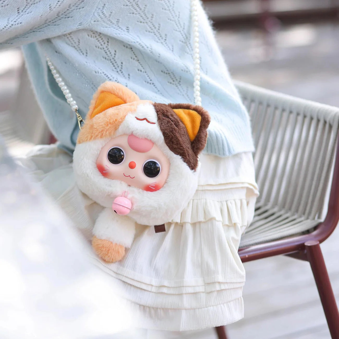 Baby Three Fortune Cat Zipper Bag Plush Blind Box featuring a stuffed animal held by a person, highlighting the collectible nature of this art toy series.