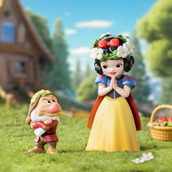 Statues of Snow White and a dwarf in a grass field, part of Disney Snow White Classic Blind Box Series from Strangecat Toys.