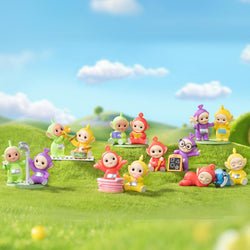 Teletubbies Companion Series Figures Blind Box Series: Preorder - Ships Late May 2024. Features 6 regular and 1 secret toy figurines. Group of small toys on grass, one in a yellow garment, another in a basket.