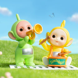 Teletubbies Companion Series Figures Blind Box Series: 6 regular, 1 secret. Toys on grass, one in green garment playing trumpet, figures on field. From Strangecat Toys, a blind box and art toy store.