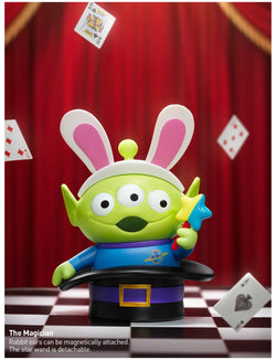 Toy alien with bunny ears and hat, holding cards and a magic wand from the Disney/Pixar Alien-Immersive Experience Blind Box Series.