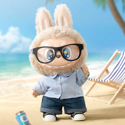 THE MONSTERS - FLIP WITH ME Vinyl Plush Doll on a beach, wearing glasses, preorder for Aug 2024, featuring mixed materials and oversized dimensions.