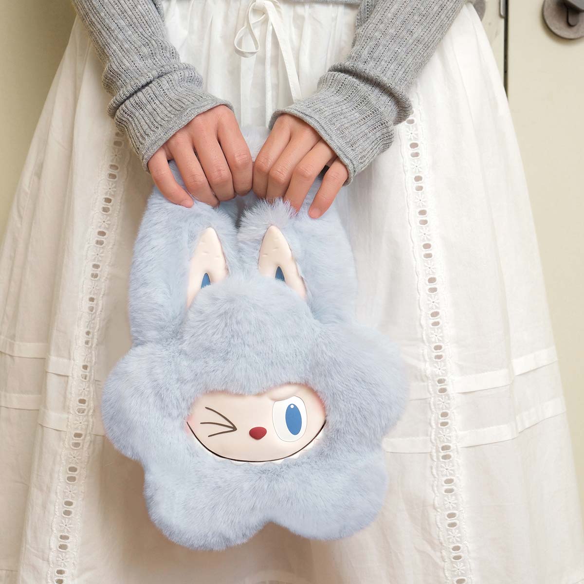 THE MONSTERS Classic Series-Plush Flower Bag Blue, a plush toy bag made of polyester and silicone, pre-order available, held by hands.