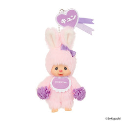 Happy Color Monchhichi Keychain featuring a pink plush toy with a purple bow, heart-shaped tag, and attached ball chain for portability.