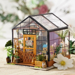 A blind box and art toy store presents Cathy's Flower House DIY Miniature Dollhouse. Detailed library setting with shelves, books, and frames. Dimensions: 12.6 x 8.1 x 2 in.