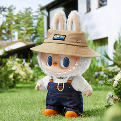 The Monsters LABUBU Fall in Wild Vinyl Plush Doll wearing overalls and a hat, featuring a cartoon face with blue eyes.