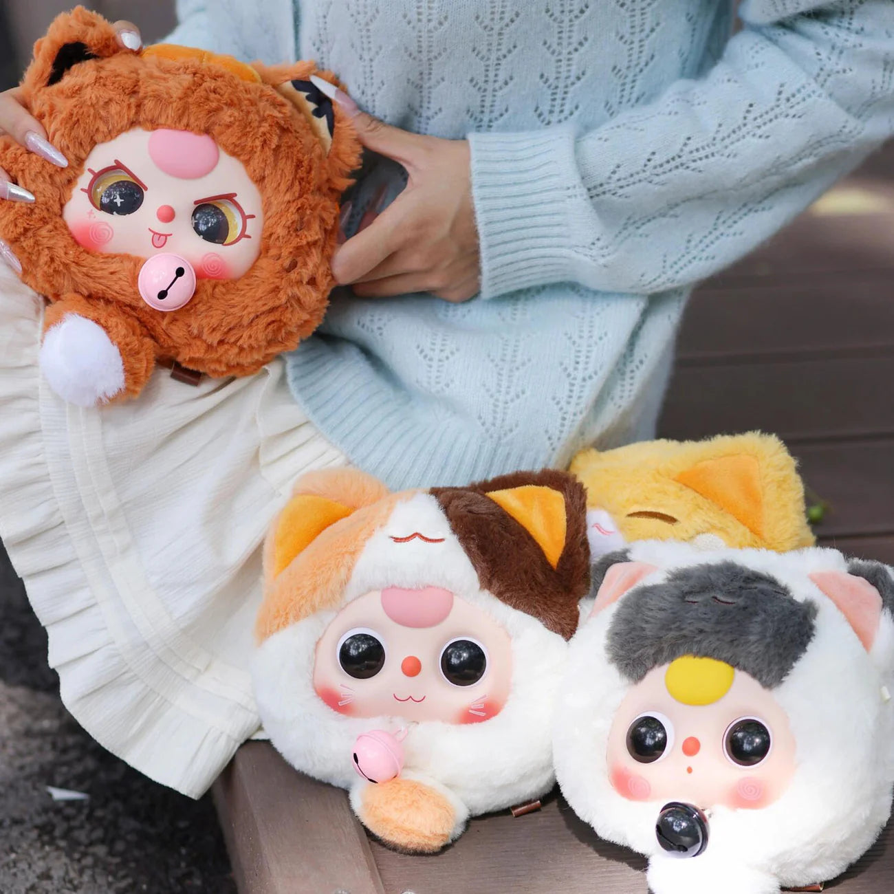 Person holding Baby Three Fortune Cat Zipper Bag Plush Blind Box, featuring a stuffed animal from Strangecat Toys' collection of blind box art toys.