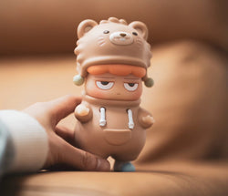 A hand holding a cartoon figurine toy, featuring POH Bear by Vin. Preorder - Ships Late May 2024.