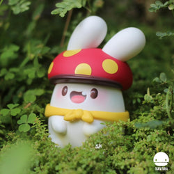 A vinyl lawn ornament toy named Ngaew Ngaew The Adventure Mushroom by Ngaew, with a removable hat and scarf, placed in grass.