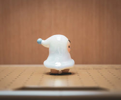 A vinyl toy featuring The Ghost - The Original White by Pucky, a small white animal figure indoors.