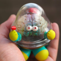 A hand holds Mr.Brain - Brains Attacks toy, a 9 cm tall sofubi/resin figure. Preorder - Ships Late May 2024. From Strangecat Toys.