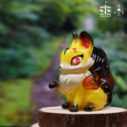 A blind box toy: Koma itsune - Yellow Amber by Genkosha. A phantom fox angel figurine with snow-white hair and silver-purple flames, protecting villagers from a snowstorm.