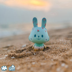 A blind box art toy: Limited edition Sofy Vinyl toy rabbit in sand, 10cm. Product title: Summer Robin by Kotton Factory.