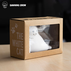 Preorder THE WHITE CAT vinyl toy by Dawning Crow in a blind box. 11.5cm. Image: white cat figurine in a box.