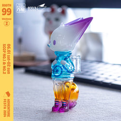 A limited edition soft vinyl toy, 0313 x okluna - Traveler Phase 3, 11cm tall, featuring a plastic figurine of a cartoon character holding a bag. From Strangecat Toys.