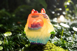 Monster Mallow - Rainbow Fluffy resin toy by MUPA, 10 cm, limited to 80 pieces, displayed on a mossy surface.