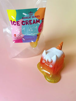 Toy in a plastic bag depicting Too Hot! Ice Cream Cat by Rato Kim, featuring resin material and artificial fur, shaped like a cat.