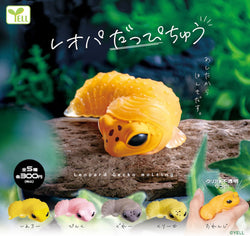 Leopard gecko Gacha Series toy on preorder, featuring a small yellow lizard toy on a log, available from Strangecat Toys.