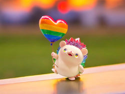 Hogkey Rainbow Heart Balloon: A 12 cm resin toy hedgehog holding a heart-shaped rainbow balloon, embodying the playful spirit of Strangecat Toys' art collection.