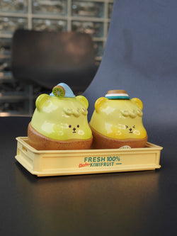 Han Han kiwi fruit toy bears on tray, one with blue hat, resin material, indoor sitting toy.