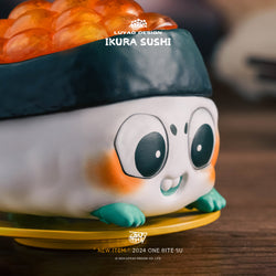 One Bite SU Blind Box Series toy sushi on a yellow plate, featuring cartoon elements, part of a collectible range with regular and secret designs.