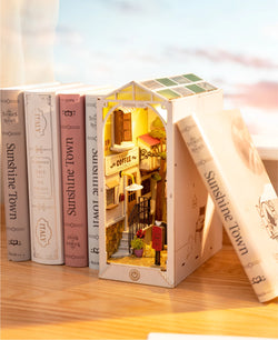 A DIY miniature house book nook featuring Sunshine Town theme, ideal for book lovers. Dimensions: 9.1 x 12.2 x 1.8 in. From Strangecat Toys, a blind box and art toy store.