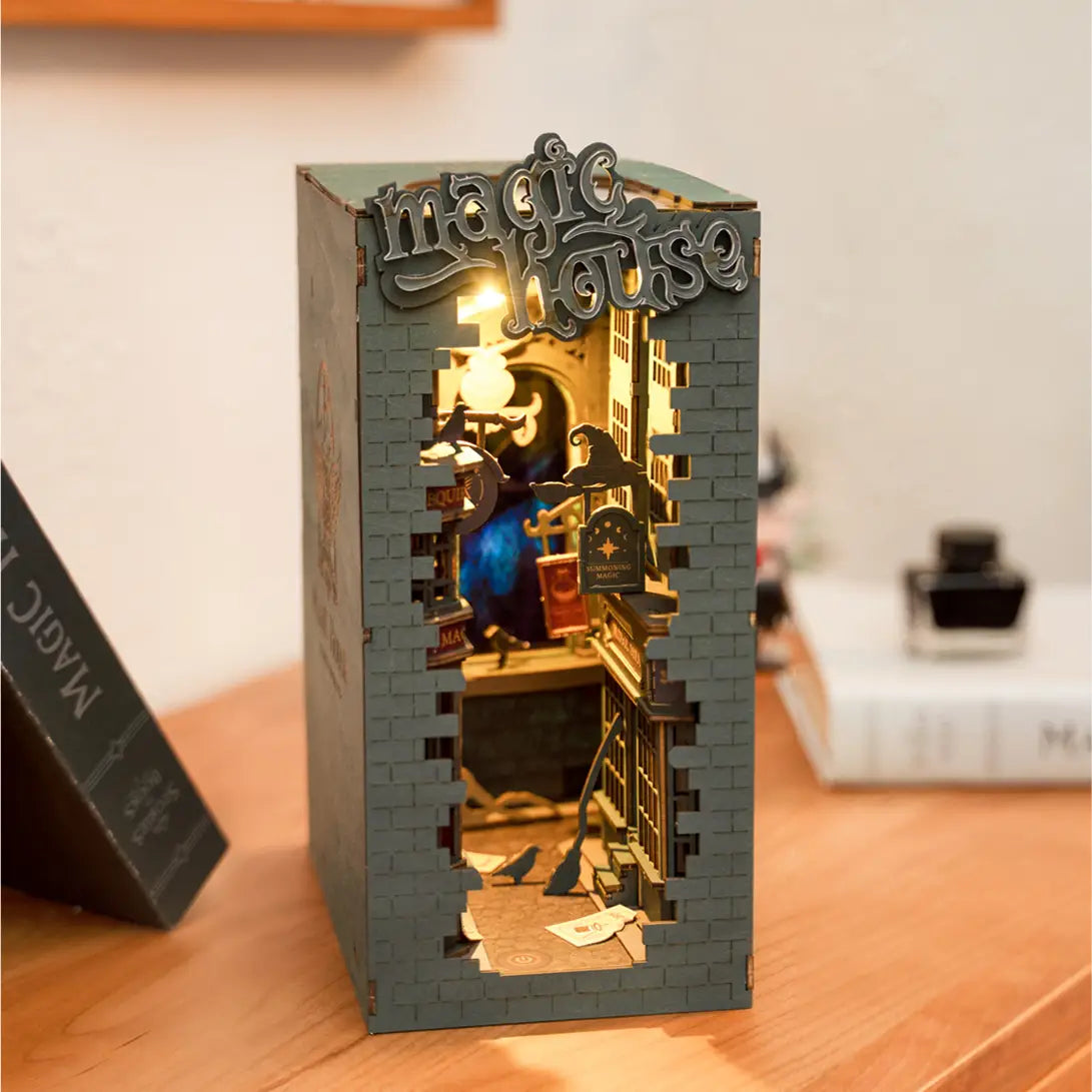 A DIY miniature book nook kit featuring a magic house design. Perfect for adults. Dimensions: 9.1 x 12.2 x 1.8 in. From Strangecat Toys, a blind box and art toy store.