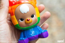 A hand holds the 10cm Jrbo Rainbow Edition by JWON, a resin art toy available for preorder, shipping in July 2024.