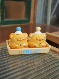 Hanhan egg puffs by Unknown Island - Preorder. Resin salt and pepper shakers shaped like yellow bears with hats, on a tray.