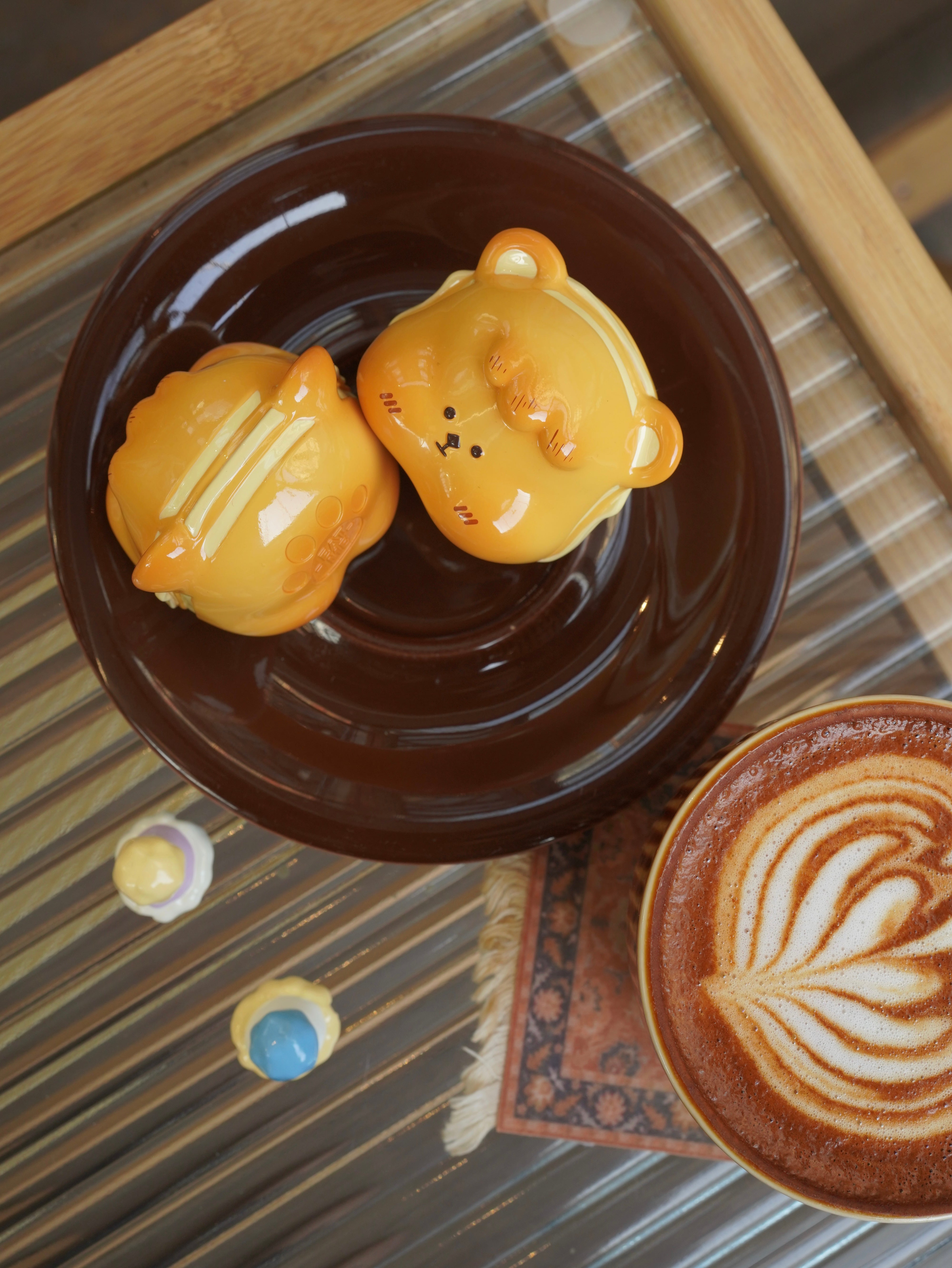 Hanhan egg puffs by Unknown Island - Preorder. Resin figures shaped like bears on a plate, with a cup of coffee. Ships Aug 2024.