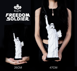 A woman holding a statue of a person with a white object, part of the Freedom Soldier - Preorder collection.