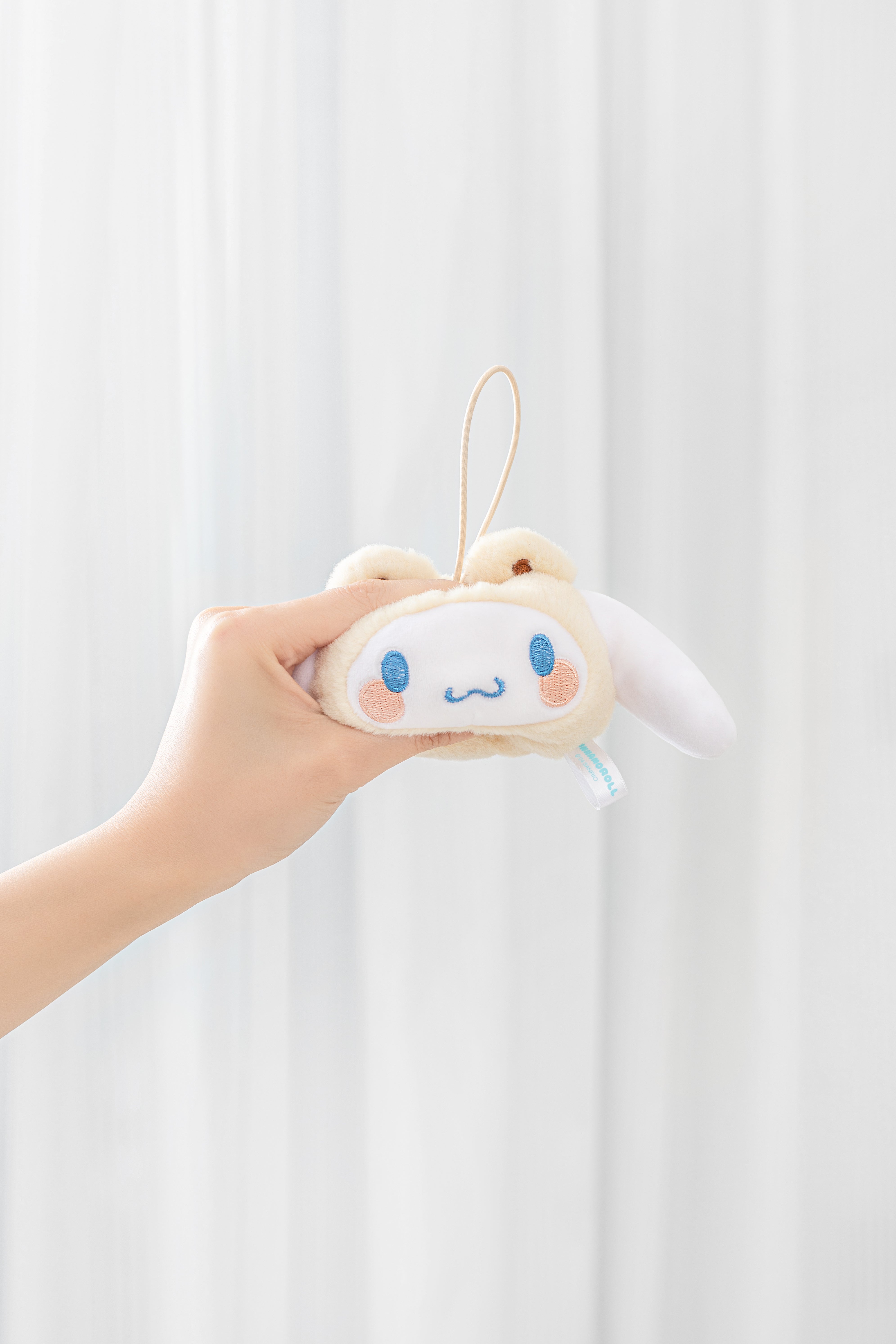 Hand holds Sanrio characters Cross Dressing Series Plush Relaxing Toy keychain, emphasizing its soft, detailed design, suitable for blind box collectors.