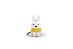 A Miffy Reading Keychain featuring a white rabbit holding a yellow book, a toy perfect for ages 3 and up. From Strangecat Toys.