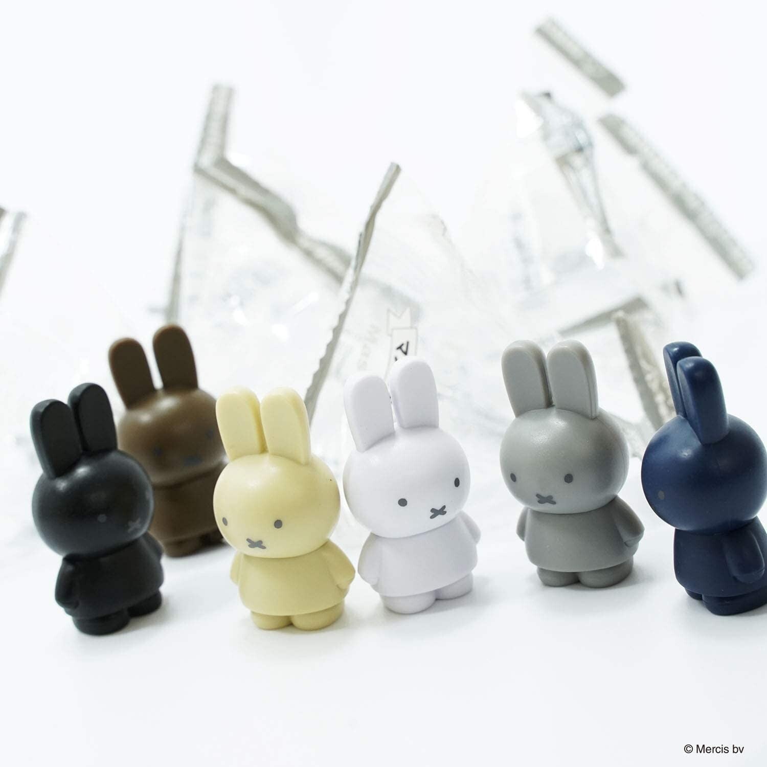 A blind box toy set from Strangecat Toys: Miffy Mystery Bag Series. Includes 12 small plastic rabbits in 6 colors. Each rabbit measures approximately 45 x 23 x 20mm.