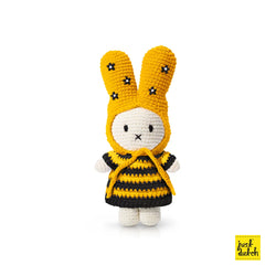 A knitted doll with bunny ears and a flower hat, Miffy Bumble Bee Dress Crochet Plush. Toy design from the Netherlands. Size: 3.5x2.4x1.6, Weight: 0.03lb.
