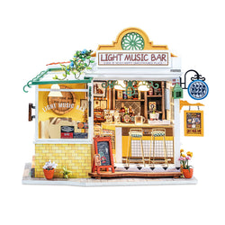 A miniature light music bar DIY wooden dollhouse with flowers, plants, chair, rails, window, and more. Includes assembly tools and English instructions. Dimensions: 12.6 x 8.1 x 2 in.