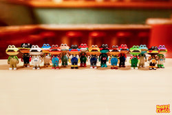 Burger Kun Blind Box Series toy figurines with a group of small toys and a toy frog in a red and white striped shirt.