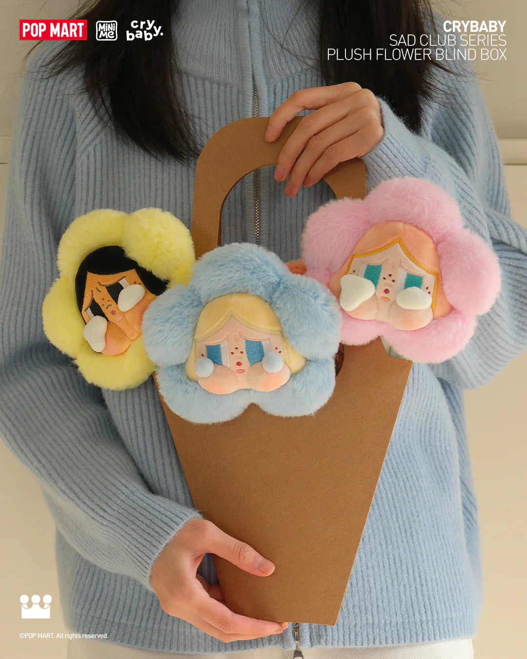 A woman holding a basket with CRYBABY Sad Club Series-Plush Flower Blind Box stuffed toys.