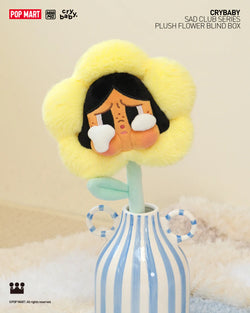 Alt text: CRYBABY Sad Club Series plush flower in a blue and white striped vase, available for preorder, ships July 2024.